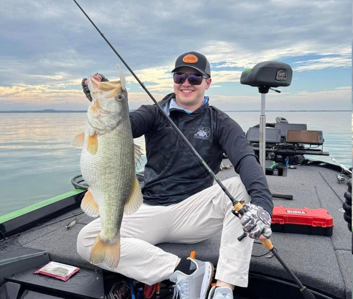 Angler holding a bass on a fishing boat