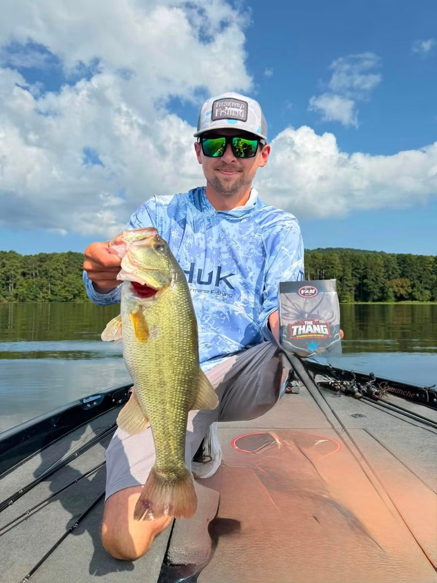 Angler with a bass and The Thang bait